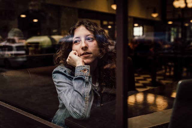 Woman by window thinking